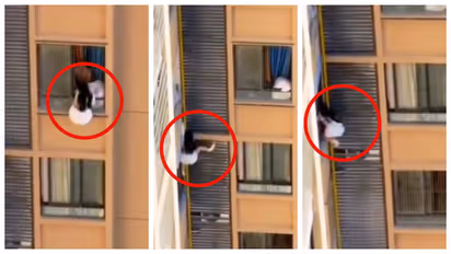 woman dangles from 10th floor balcony