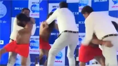 Baba Ramdev wrestling with a journalist