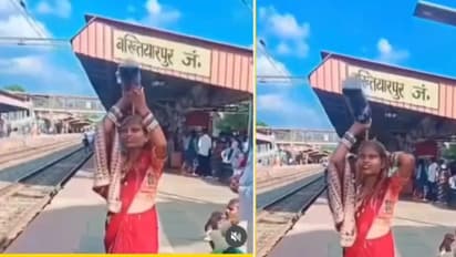 Woman Bathes in Cold Drink at Railway Station