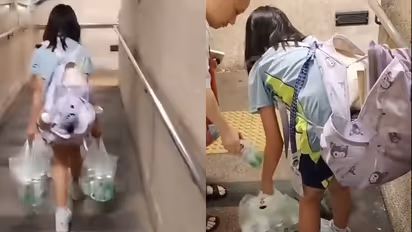 Hong Kong Girl Filmed Carrying Heavy Beer Cans