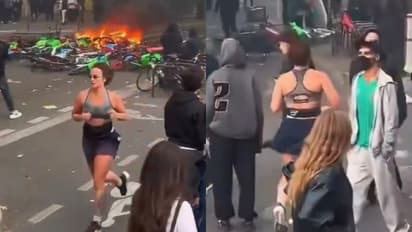 Woman Jogs Past Burning Debris Amid Riots In France