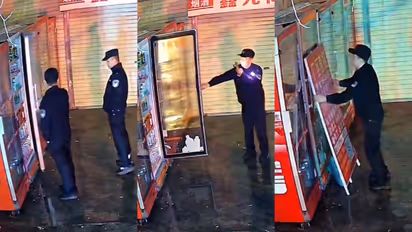 Chinese police officers guard a broken vending machine overnight
