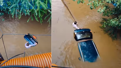 Man Braves Floodwaters to Save the Car