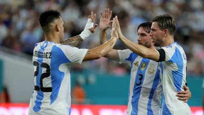 Argentina players celebrate goal against Venezuela