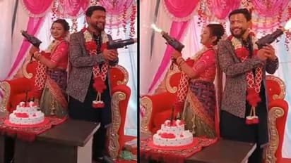 bride groom photographed with were posing with guns then fire on the face of the bride