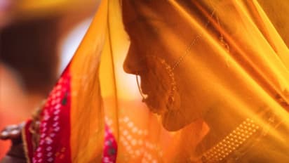 The bride in red attire under the veil