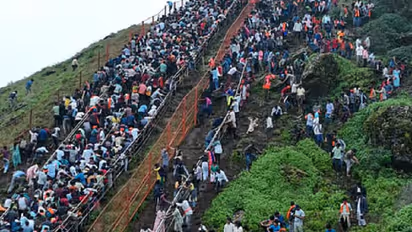 Thousands of devotees ascending Bindiga Deviramma Hill for darshan amid rain in Chikkamagaluru