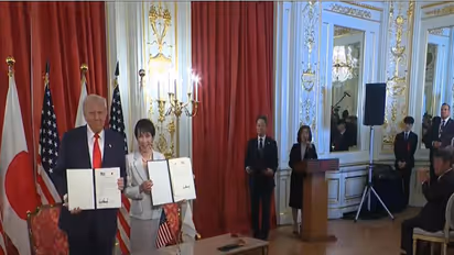 US President Donald Trump and Japanese Prime Minister Sanae Takaichi hold signed agreements during a ceremony in Tokyo. (Image: The White House/YouTube)