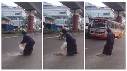 woman filling pothole