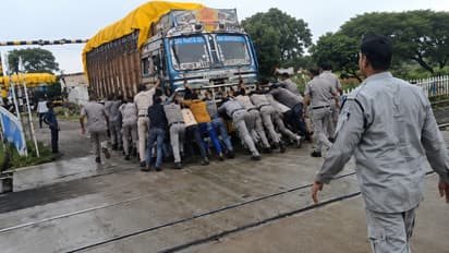 MP Cops Push Loaded Truck Off Railway Tracks As Freight Train Closes In Behind Them