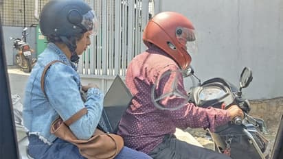 woman working on laptop stuck in traffic