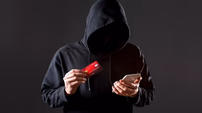 Male hacker holding smartphone