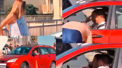 woman holds topless car wash board on road