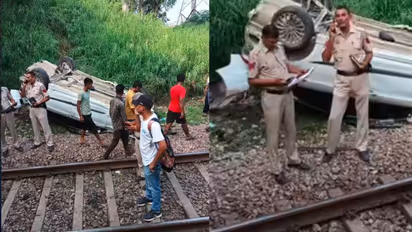 Car Plunges onto Railway Tracks