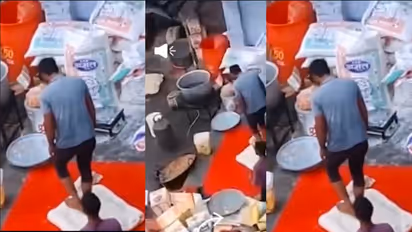 maida being kneaded with feet to prepare sweets