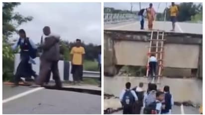 children use bamboo ladder to climbing a fallen bridge to go to school