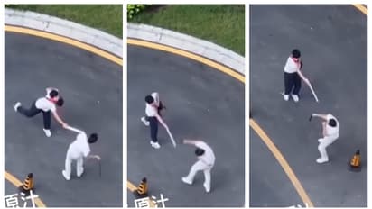 father hitting son who failed in the exam through the street