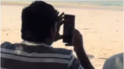 indian man photographing foreign women