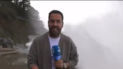 Spanish reporter warns of rough seas, gets knocked down by giant wave on live TV