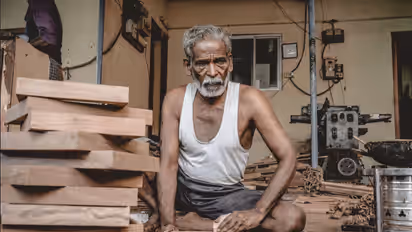 Vinay Kumar Nevatia, custom carpenter, oiling a solid wood table