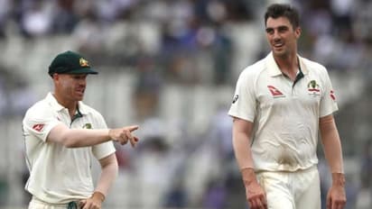 Pat Cummins with David Warner