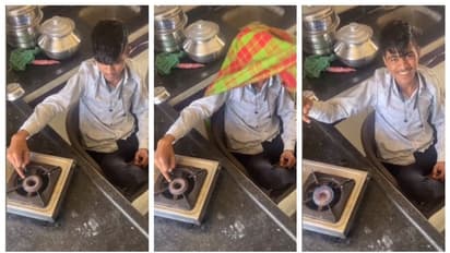 boy lighting gas stove using his finger