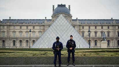 Police stand guard outside the Louvre museum at Louvre in Paris, France.