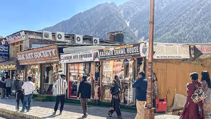 Tourists walk past shops following the Pahalgam terror attack, at Pahalgam in Anantnag on Monday (Photo/ANI)