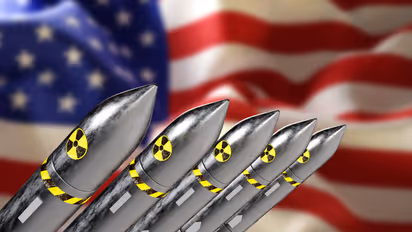 Nuclear missiles on background of blurred USA flag