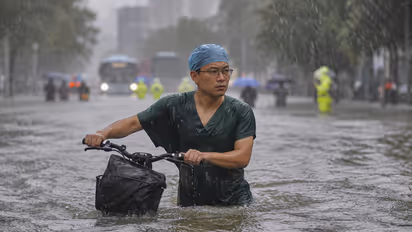 Chinese Doctor Becomes Hero After Braving Floodwaters on Bicycle for Surgeries