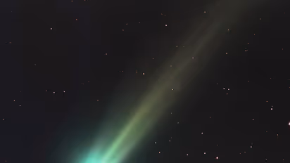 Green comet in the night sky