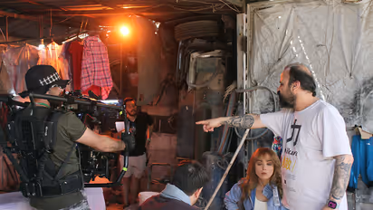Syrian director Mohamad Abdul Aziz, shows Abdul Aziz (R) giving directions to actors during the filming of the TV series "The King's Family" in Damascus.