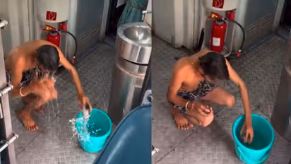 Indian Railways Passenger bathes inside coach 