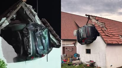 car crashes into barn roof