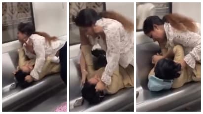 women fight over a seat in the Delhi Metro