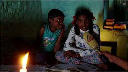 children studying by candle light