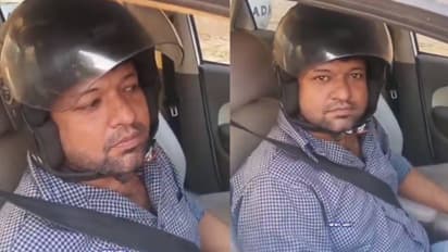 Man wears helmet while driving car after fine