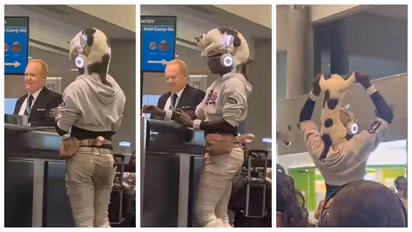 woman walks airport with a cat