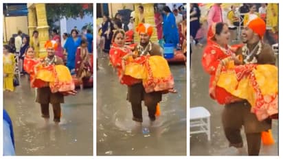 Groom Carries Bride after heavy rain