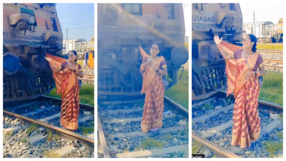 woman ties saree to train engine
