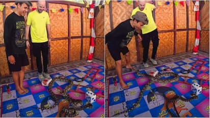 Boy Plays Snakes And Ladders With Real Pythons, Narrowly Escapes Bite As One Suddenly Strikes