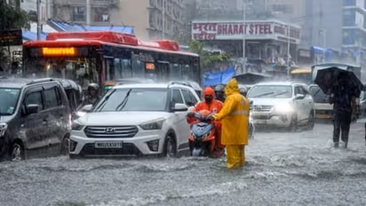 mumbai heavy rain imd red alert waterlogging vasai virar ghatkopar local trains monsoon