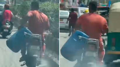 Caught on Camera: Delhi Man Spills Garbage on Road While Riding Bike, Viral Video Sparks Outrage | WATCH
