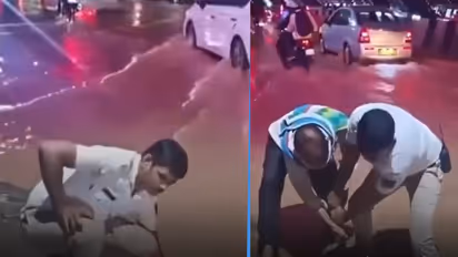 Bengaluru traffic cop clears blocked drain amid heavy rain