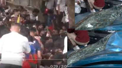  A car was damaged after fans climbed over it outside