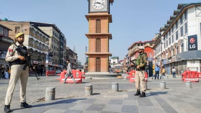 J&K police personnel stand guard at Lal Chowk 