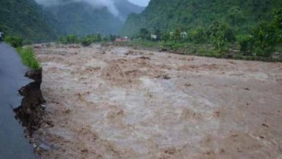 పొంగిన వాగు, ఇద్దరు గల్లంతు, కొట్టుకుపోయిన ట్రాక్టర్