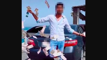 റോഡില് നോട്ടുകെട്ടുകള് വലിച്ചെറിഞ്ഞ് യുഎഇയില് പ്രവാസിയുടെ പ്രകടനം; ഒടുവില് സംഭവിച്ചത്