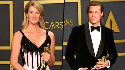 Brad Pitt and Laura Dern accept the Oscar for best supporting actor and actress