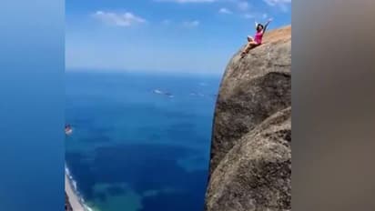 ഇത് സിനിമയിലല്ല, ഒറിജിനലാണ്; 3000 അടി ഉയരമുള്ള മലയുടെ അറ്റത്തിരുന്ന് കെെ വീശുന്ന യുവതി, വെെറലായി വീഡിയോ